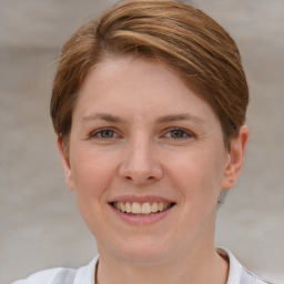 Joyful white young-adult female with short  brown hair and grey eyes