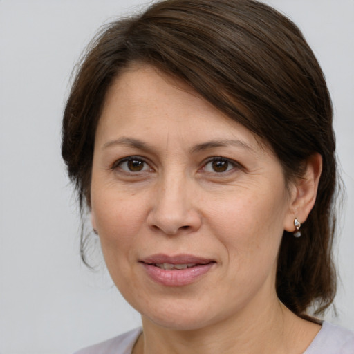 Joyful white adult female with medium  brown hair and brown eyes