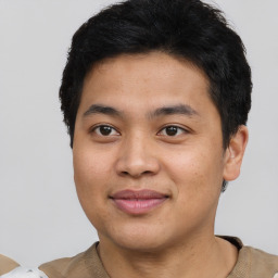 Joyful asian young-adult male with short  brown hair and brown eyes