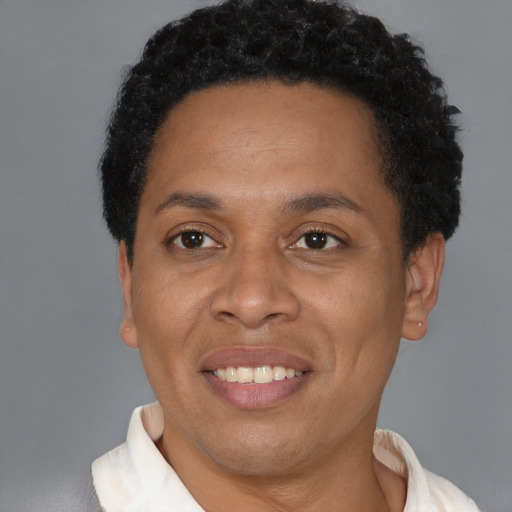Joyful black adult female with short  brown hair and brown eyes