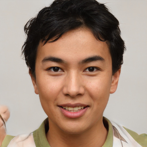 Joyful asian young-adult male with short  brown hair and brown eyes