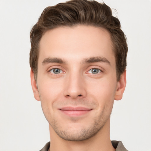 Joyful white young-adult male with short  brown hair and grey eyes