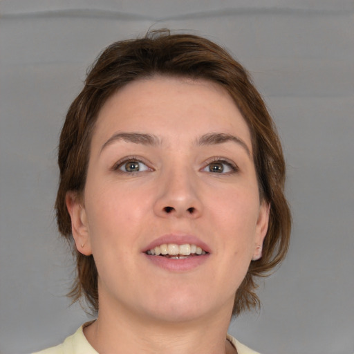 Joyful white young-adult female with medium  brown hair and grey eyes