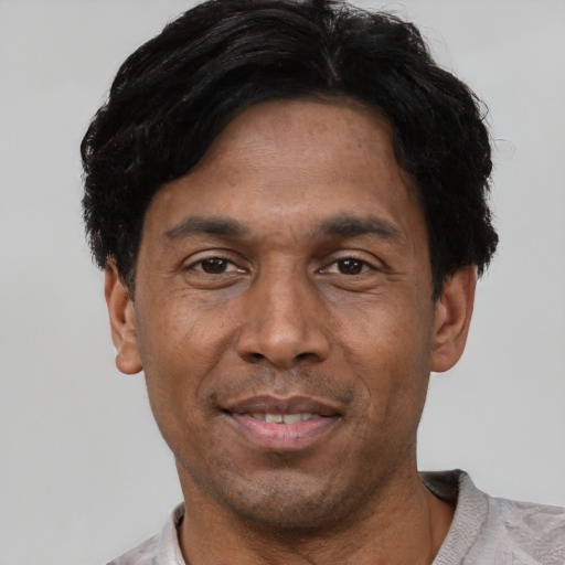 Joyful asian adult male with short  black hair and brown eyes