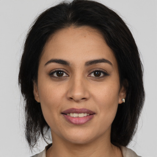 Joyful white young-adult female with medium  brown hair and brown eyes