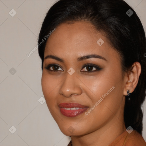 Joyful latino young-adult female with long  black hair and brown eyes