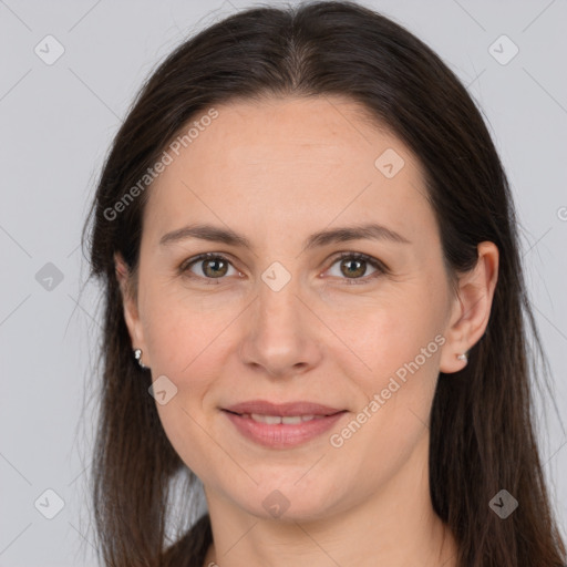 Joyful white adult female with long  brown hair and brown eyes