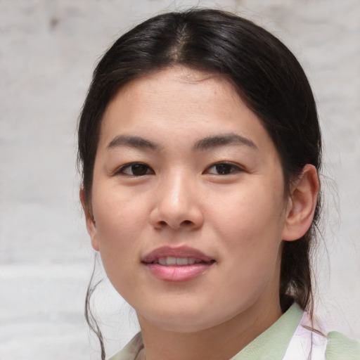 Joyful asian young-adult female with medium  brown hair and brown eyes