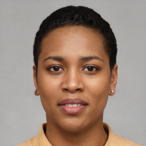 Joyful black young-adult female with short  black hair and brown eyes
