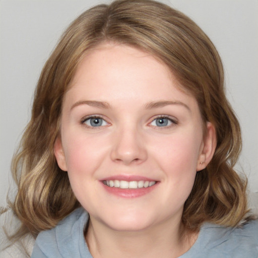 Joyful white young-adult female with medium  brown hair and blue eyes