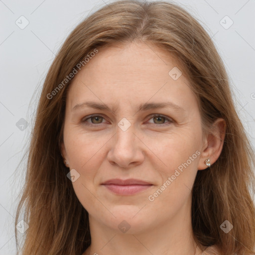 Joyful white adult female with long  brown hair and brown eyes