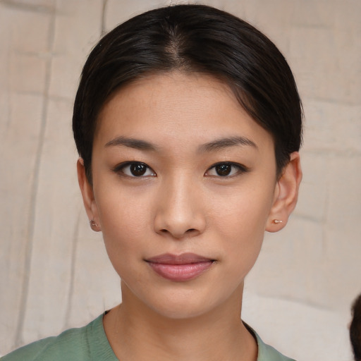 Joyful asian young-adult female with short  brown hair and brown eyes