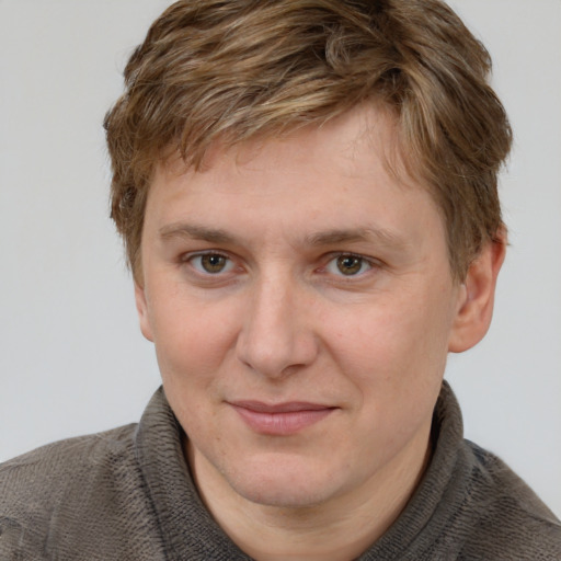 Joyful white adult male with short  brown hair and grey eyes