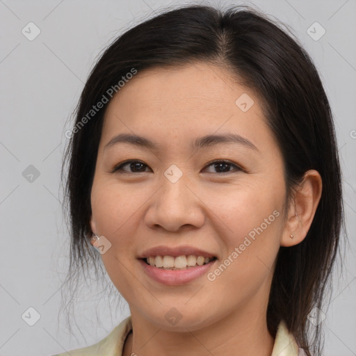 Joyful asian young-adult female with medium  brown hair and brown eyes