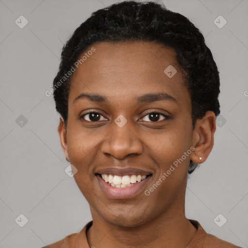 Joyful black young-adult female with short  black hair and brown eyes