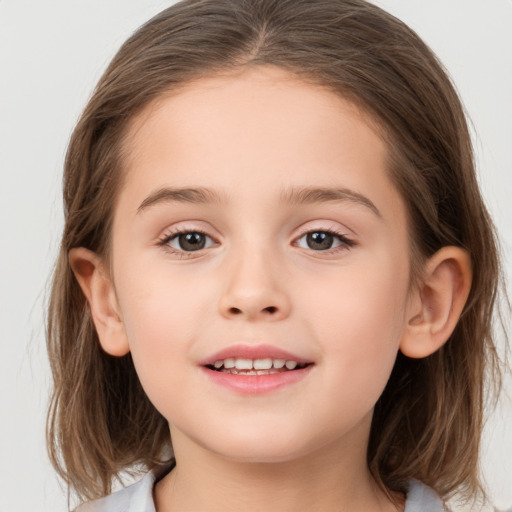 Joyful white child female with medium  brown hair and brown eyes