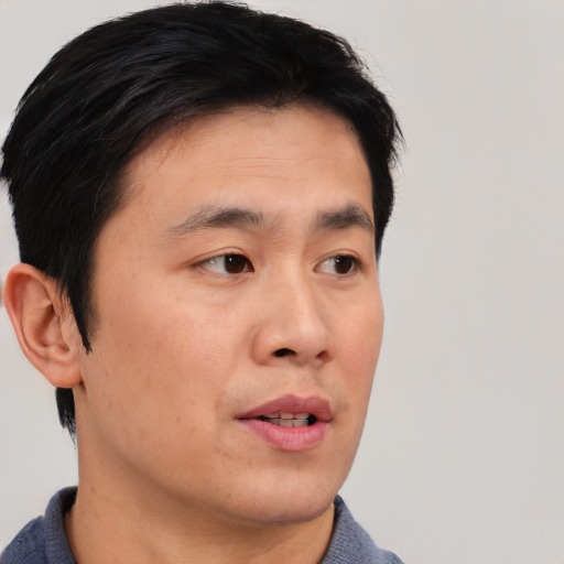 Neutral asian young-adult male with short  black hair and brown eyes