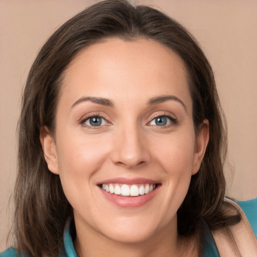 Joyful white young-adult female with long  brown hair and blue eyes