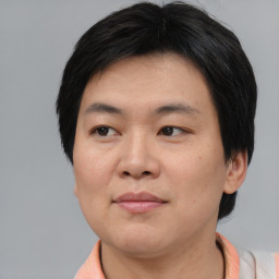 Joyful asian young-adult male with short  black hair and brown eyes