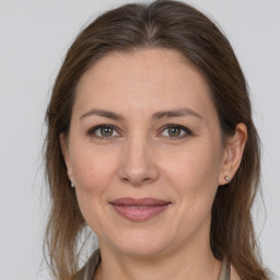 Joyful white adult female with medium  brown hair and grey eyes