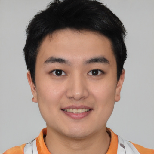 Joyful asian young-adult male with short  black hair and brown eyes