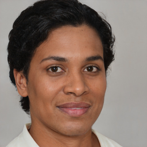 Joyful latino adult female with short  brown hair and brown eyes