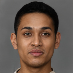 Joyful latino young-adult male with short  brown hair and brown eyes