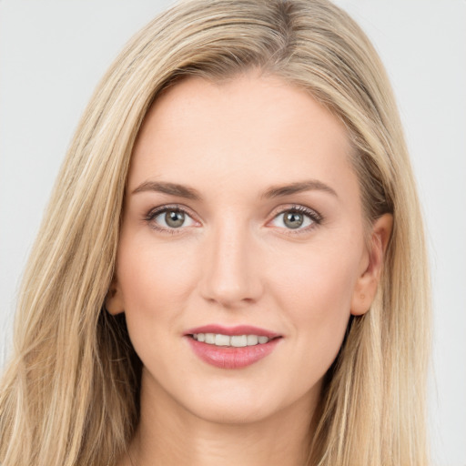 Joyful white young-adult female with long  brown hair and green eyes