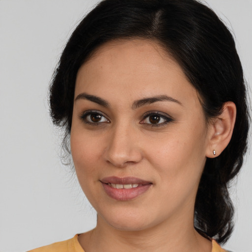 Joyful latino young-adult female with medium  brown hair and brown eyes