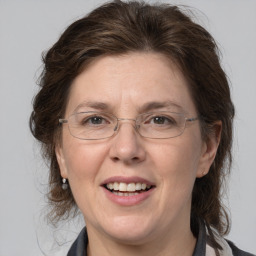 Joyful white adult female with medium  brown hair and grey eyes