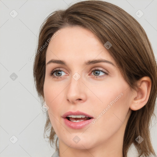 Joyful white young-adult female with medium  brown hair and green eyes