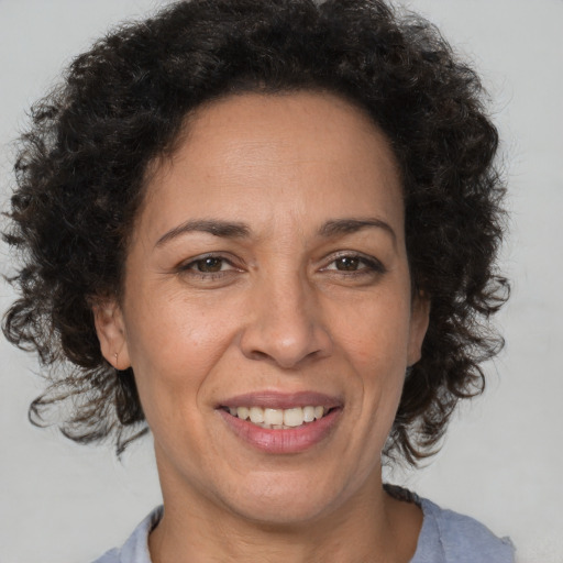 Joyful black adult female with short  brown hair and brown eyes