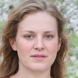 Joyful white young-adult female with medium  brown hair and blue eyes