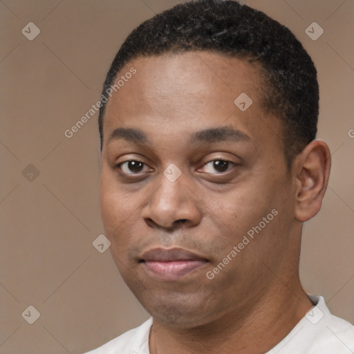 Joyful black young-adult male with short  brown hair and brown eyes