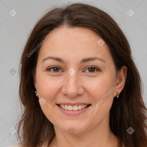 Joyful white adult female with long  brown hair and brown eyes