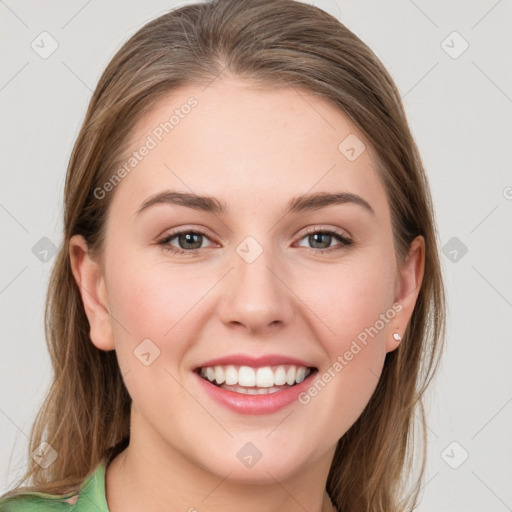 Joyful white young-adult female with medium  brown hair and green eyes