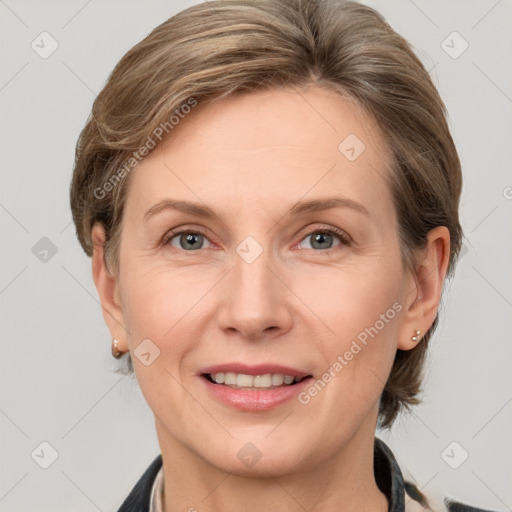 Joyful white adult female with short  brown hair and grey eyes