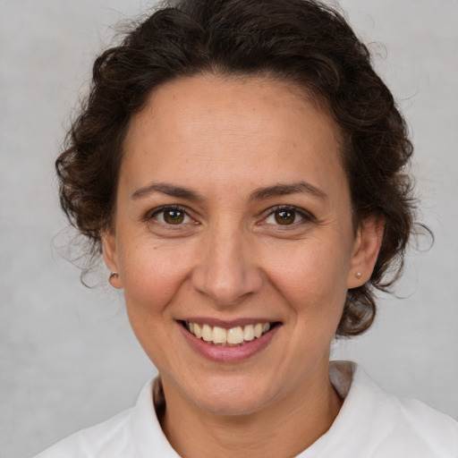 Joyful white adult female with medium  brown hair and brown eyes