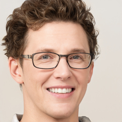 Joyful white adult male with short  brown hair and blue eyes