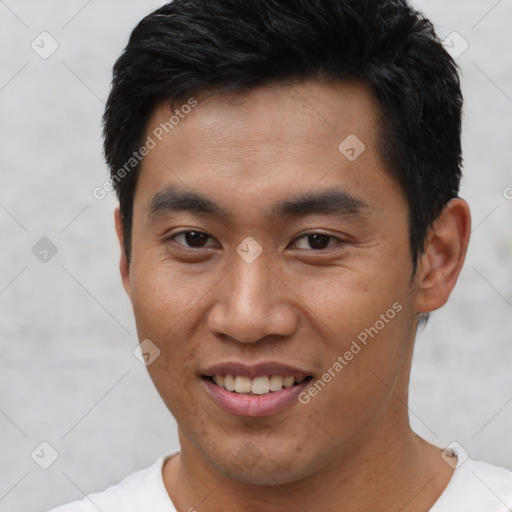 Joyful asian young-adult male with short  black hair and brown eyes