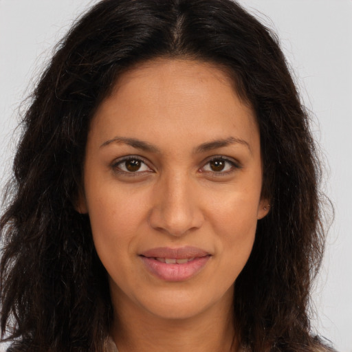 Joyful latino young-adult female with long  brown hair and brown eyes