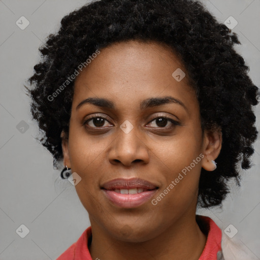 Joyful black young-adult female with long  black hair and brown eyes