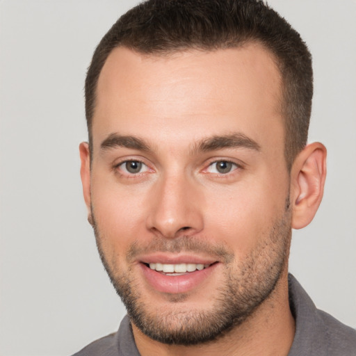 Joyful white young-adult male with short  brown hair and brown eyes