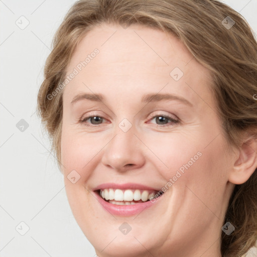 Joyful white young-adult female with medium  brown hair and green eyes