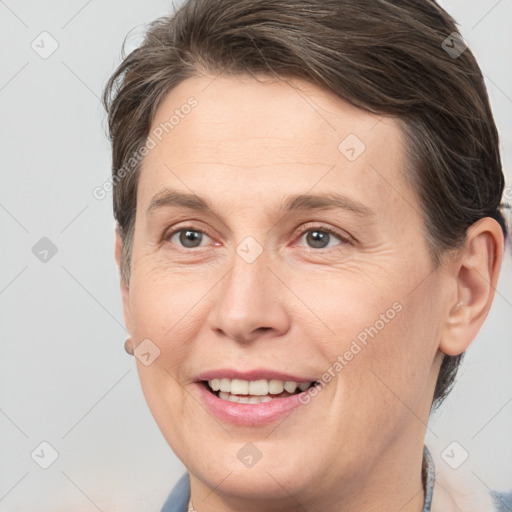 Joyful white adult female with medium  brown hair and brown eyes