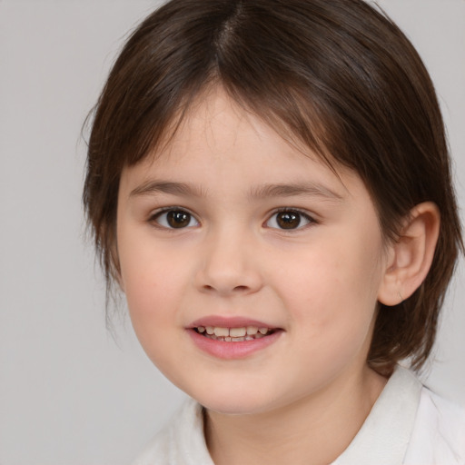 Joyful white child female with medium  brown hair and brown eyes