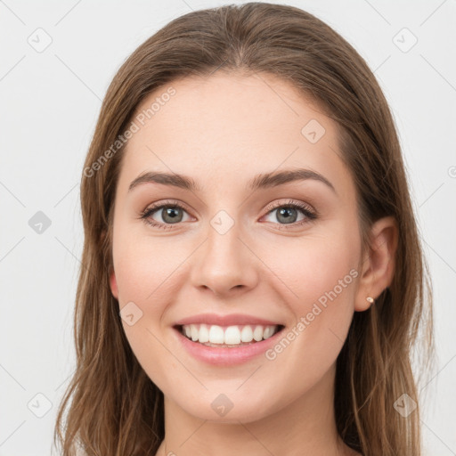 Joyful white young-adult female with long  brown hair and green eyes