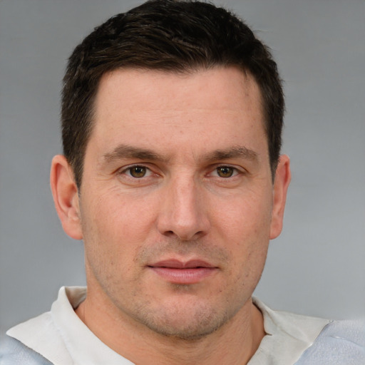 Joyful white adult male with short  brown hair and grey eyes