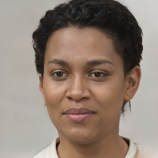 Joyful black young-adult female with short  brown hair and brown eyes