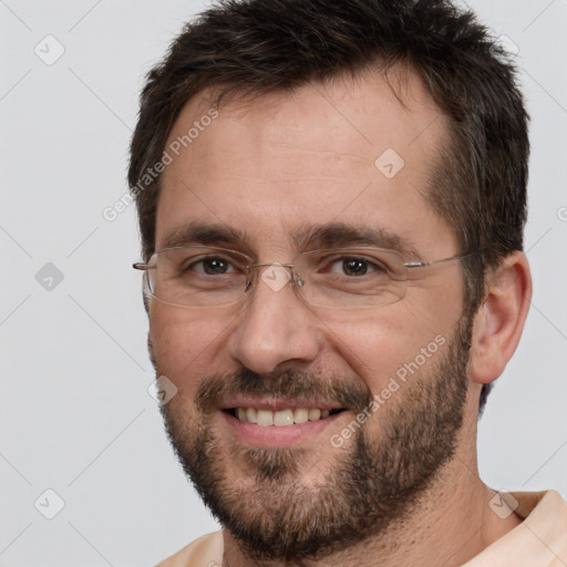 Joyful white adult male with short  brown hair and brown eyes